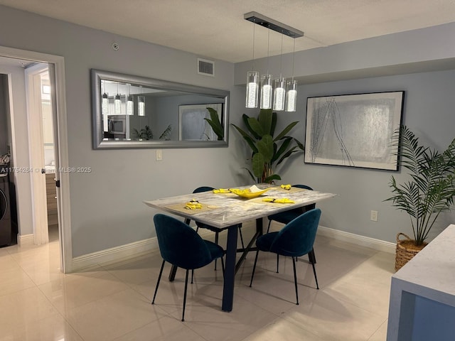 dining room with visible vents, baseboards, and light tile patterned floors