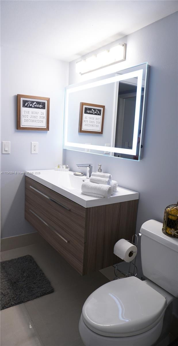 bathroom featuring toilet and vanity