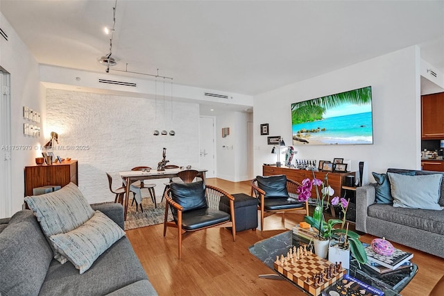 living room with visible vents and wood finished floors