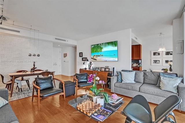 living room with light wood-type flooring and visible vents