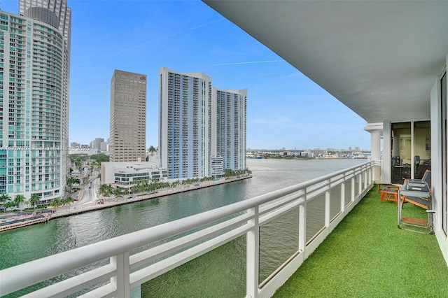 balcony featuring a city view and a water view