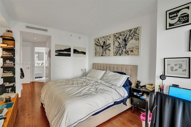 bedroom with visible vents and wood finished floors