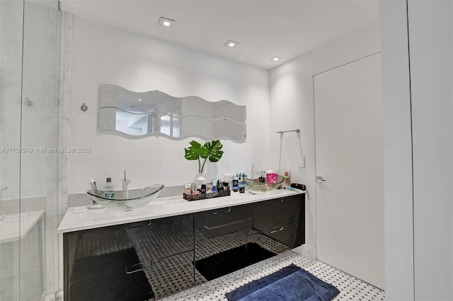 full bathroom with recessed lighting, walk in shower, and vanity