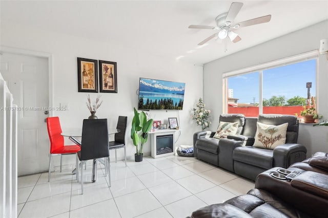 living room with a ceiling fan and light tile patterned flooring