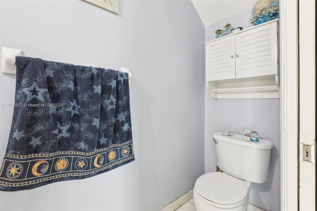 bathroom with toilet and baseboards