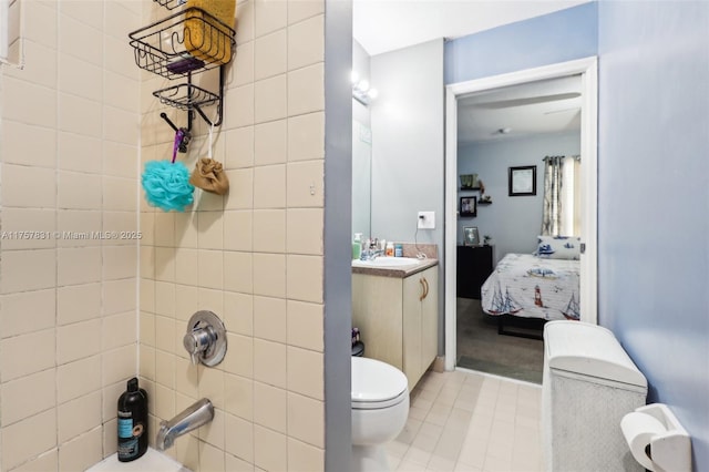 bathroom with toilet,  shower combination, ensuite bathroom, and vanity