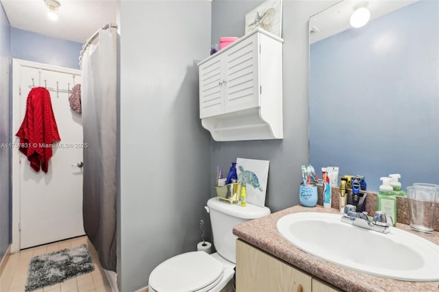 full bathroom with curtained shower, vanity, toilet, and tile patterned floors