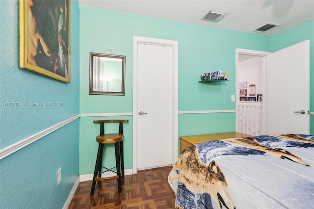 bedroom featuring visible vents and baseboards