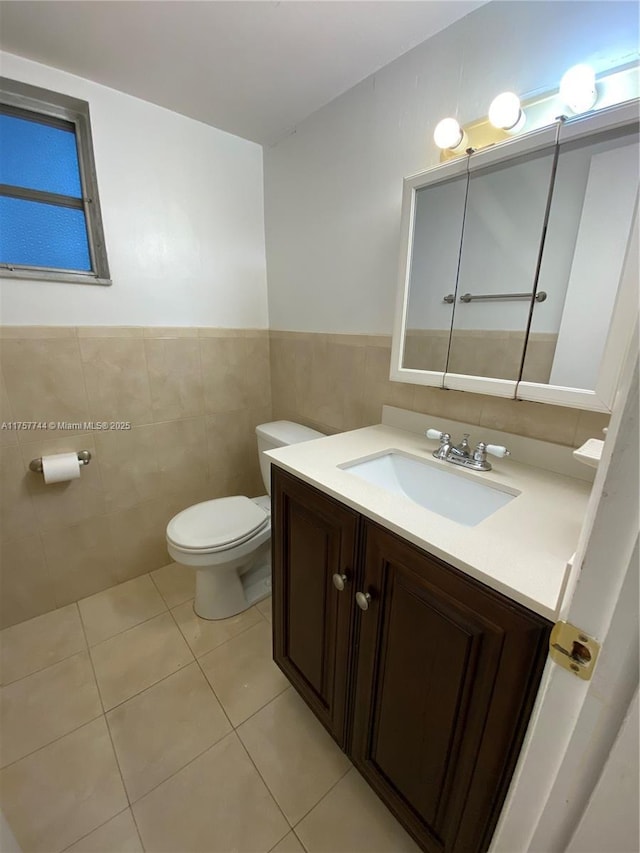 bathroom with vanity, tile walls, toilet, and tile patterned floors