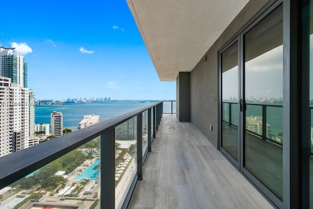 balcony with a water view and a city view