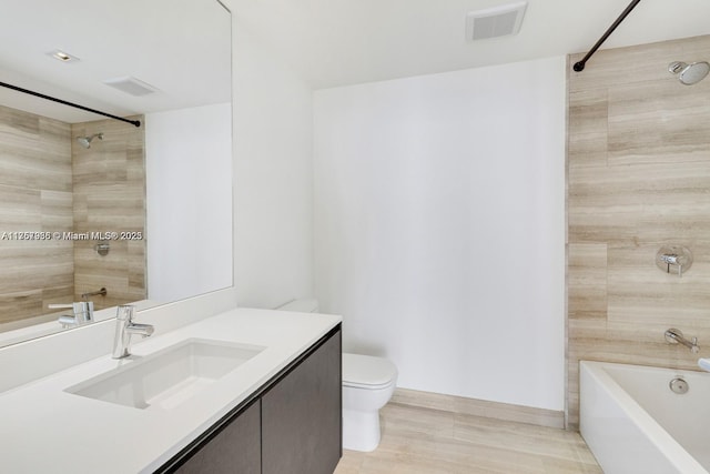 bathroom with toilet, shower / bath combination, vanity, visible vents, and baseboards