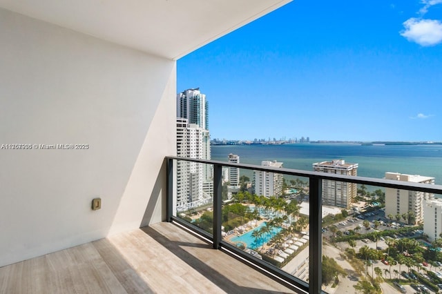 balcony with a water view and a city view