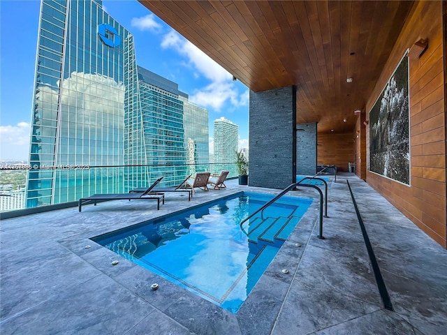 view of pool with a view of city