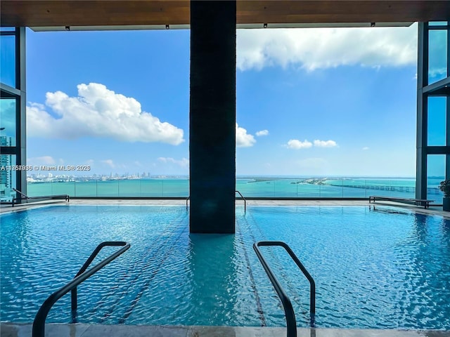 view of pool with a water view