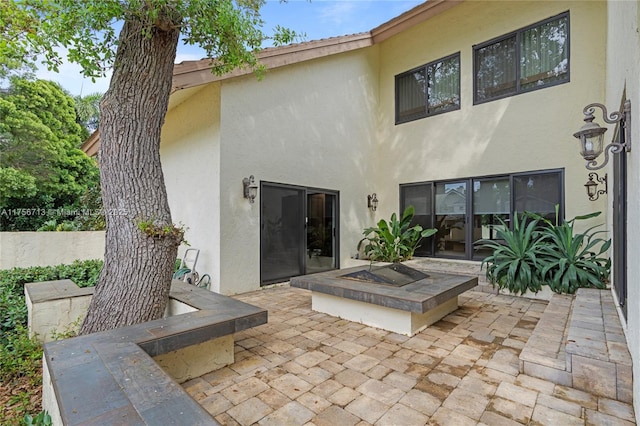 rear view of property featuring a patio area and stucco siding