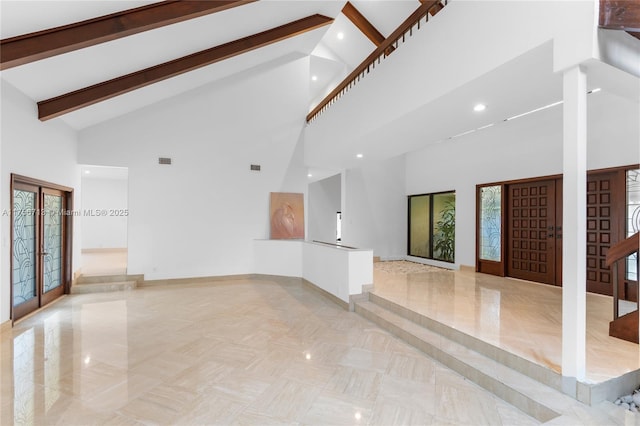 unfurnished living room with visible vents, stairway, french doors, high vaulted ceiling, and beam ceiling