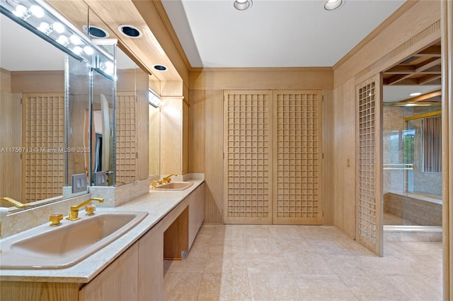 bathroom with double vanity, a sink, and recessed lighting