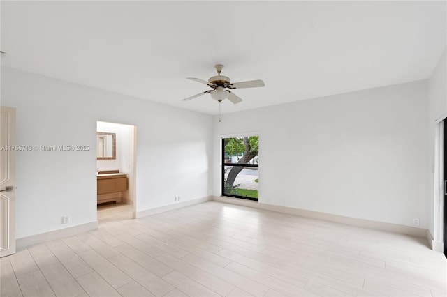 empty room featuring light wood-style flooring, baseboards, and a ceiling fan