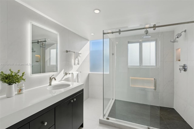 bathroom featuring a stall shower and vanity