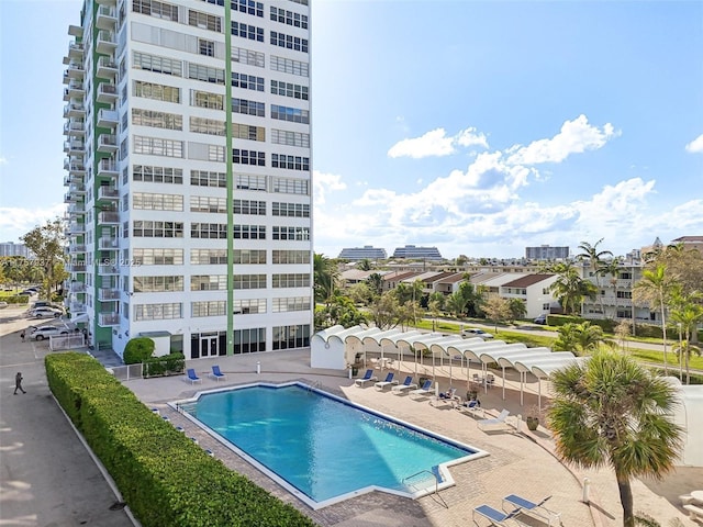 pool featuring a view of city and a patio