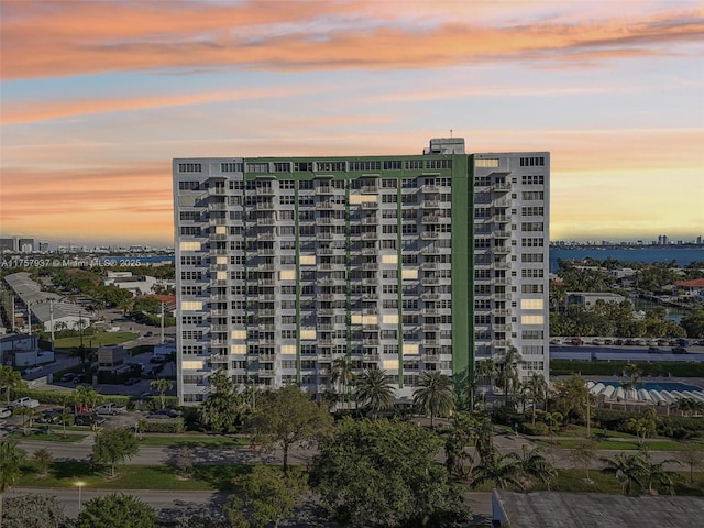 property at dusk featuring a city view