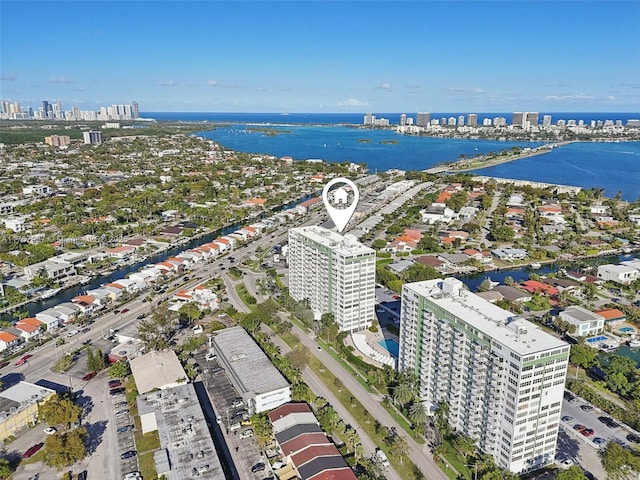 birds eye view of property featuring a water view and a city view