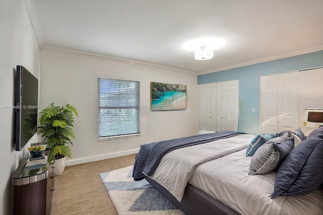 bedroom featuring multiple closets, carpet, crown molding, and baseboards