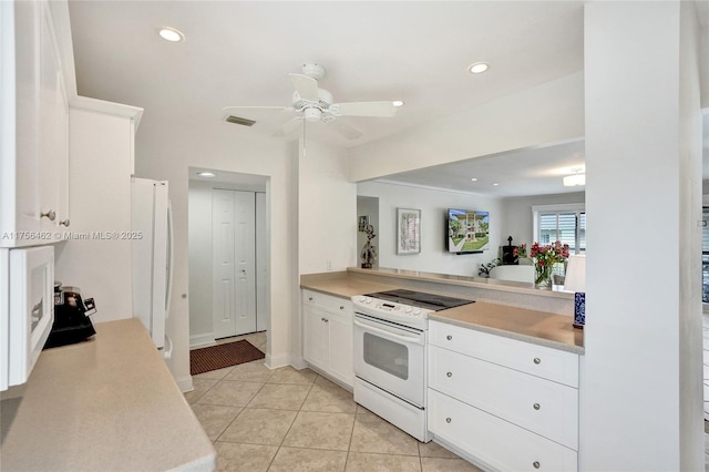 kitchen with light tile patterned floors, light countertops, white appliances, and visible vents