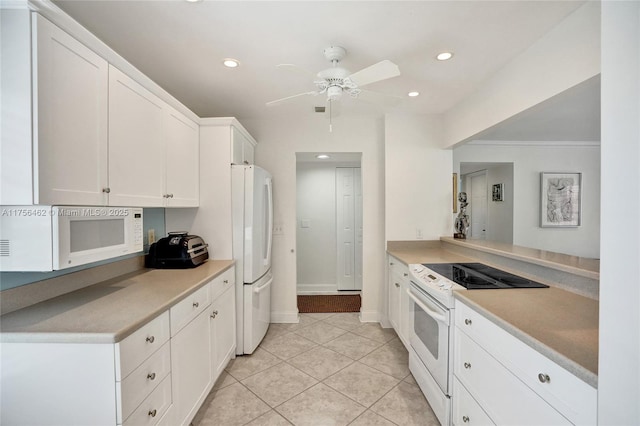 kitchen with white appliances, recessed lighting, light countertops, white cabinetry, and light tile patterned flooring