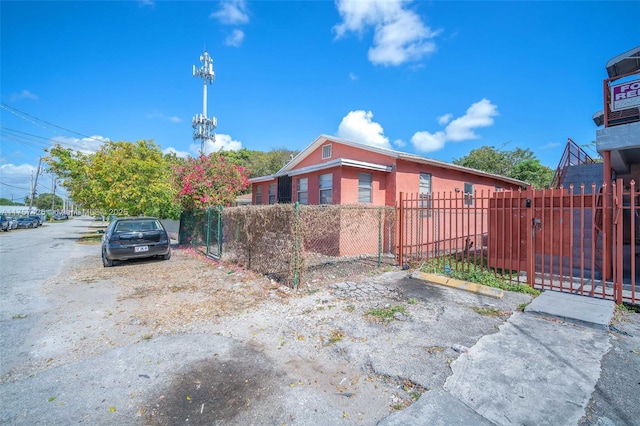 view of property exterior featuring a fenced front yard and stucco siding