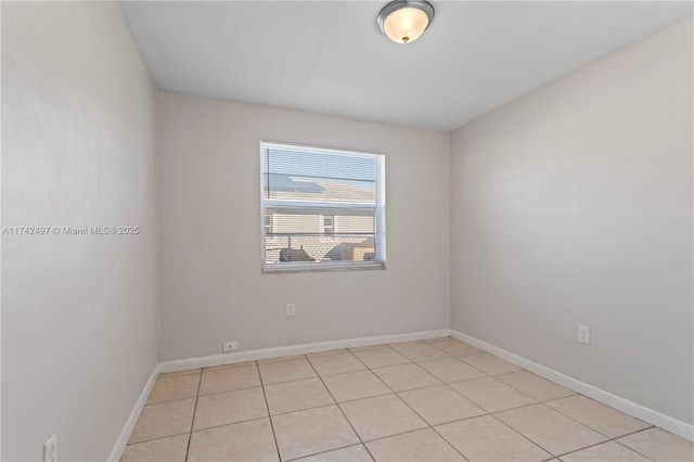 unfurnished room with baseboards