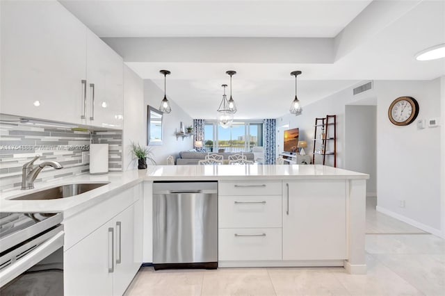 kitchen with a peninsula, a sink, light countertops, dishwasher, and tasteful backsplash