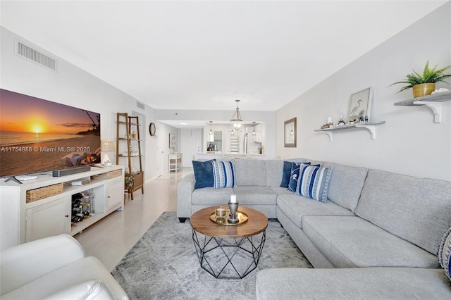 living area with a chandelier and visible vents