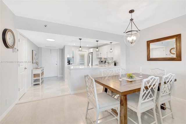 dining room featuring recessed lighting, light wood-style flooring, and baseboards