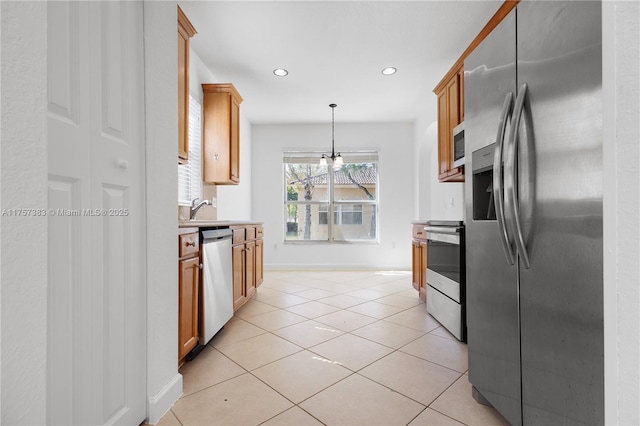 kitchen featuring light tile patterned floors, appliances with stainless steel finishes, light countertops, pendant lighting, and recessed lighting