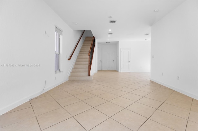 unfurnished room with light tile patterned floors, recessed lighting, visible vents, baseboards, and stairway