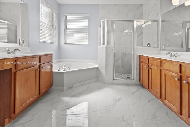 full bathroom with marble finish floor, a garden tub, a marble finish shower, two vanities, and a sink