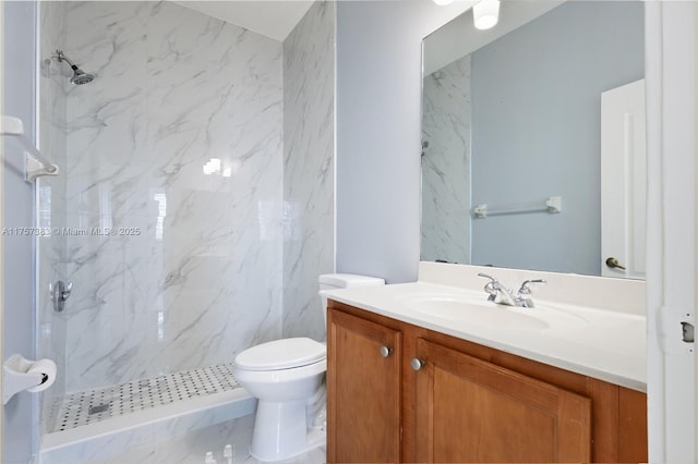 full bathroom featuring toilet, a shower stall, and vanity