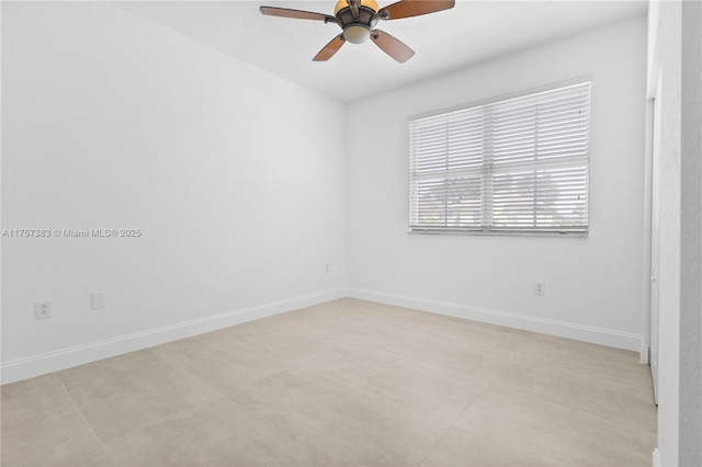 unfurnished room featuring a ceiling fan and baseboards