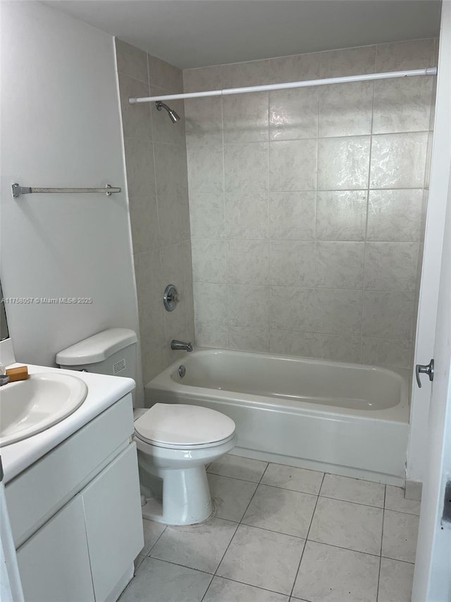 bathroom with vanity, tile patterned floors, shower / bathtub combination, and toilet
