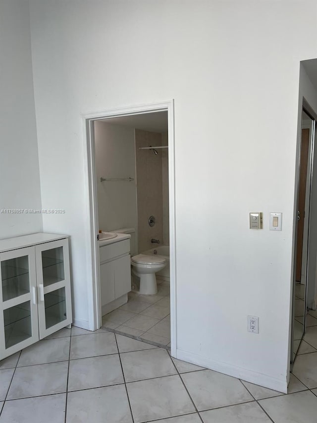 bathroom with vanity, tub / shower combination, tile patterned flooring, and toilet