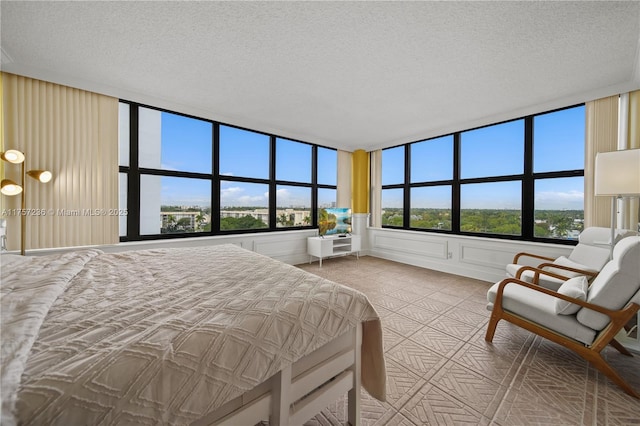 bedroom with a decorative wall and a textured ceiling