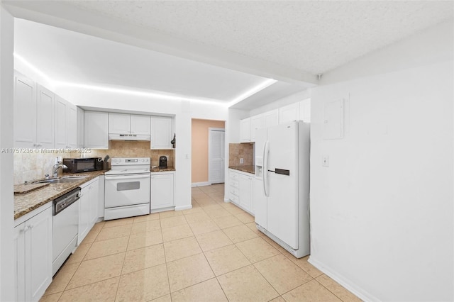 kitchen with light tile patterned flooring, under cabinet range hood, white appliances, white cabinetry, and backsplash