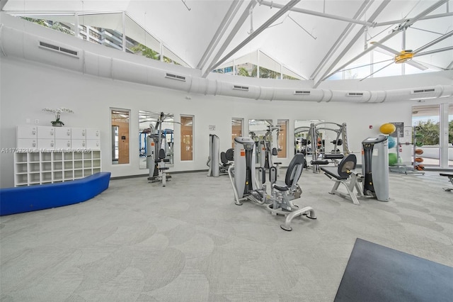 exercise room with carpet floors, lofted ceiling, and visible vents