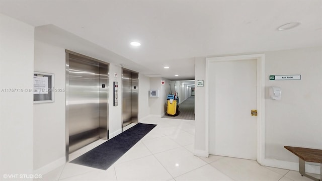 hall featuring recessed lighting, elevator, light tile patterned flooring, and baseboards