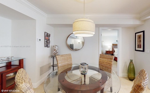 dining room with visible vents, ornamental molding, baseboards, and light tile patterned flooring