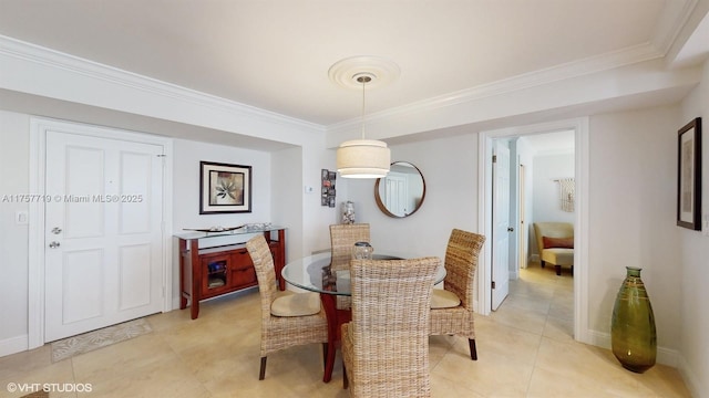 dining area featuring light tile patterned floors, baseboards, and ornamental molding