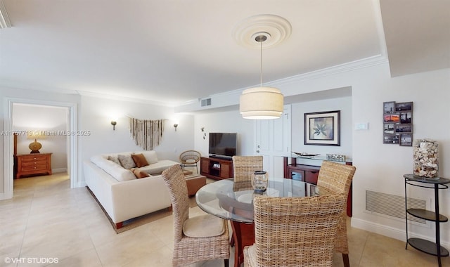 dining space featuring visible vents, crown molding, baseboards, and light tile patterned floors