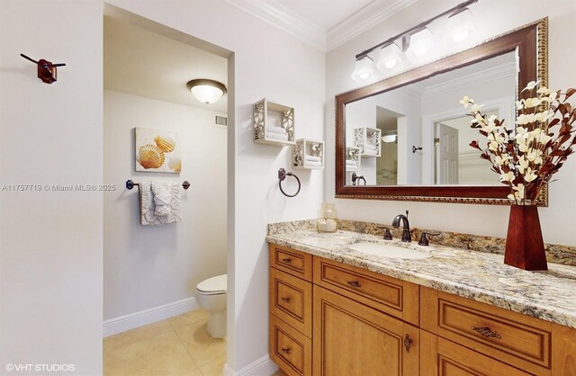 bathroom featuring crown molding, toilet, vanity, baseboards, and tile patterned floors