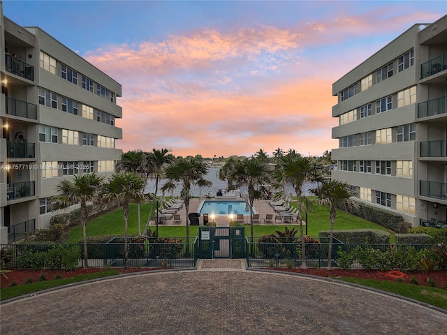 1236 Hillsboro Mile Unit 403, Hillsboro Beach, FL 33062 - property at dusk featuring fence